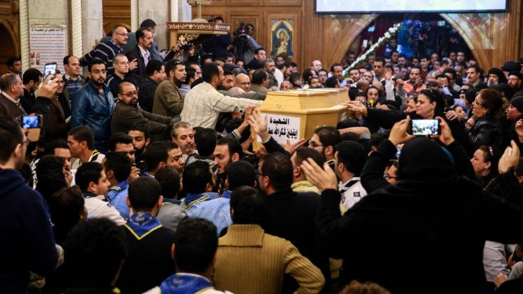 Mourners at the funeral of worshippers killed in an attack on a Coptic church south of the Egyptian capital, Cairo