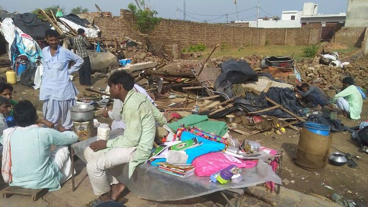 People next to their destroyed homes  in Bharatpur, India, following a severe dust storm. 