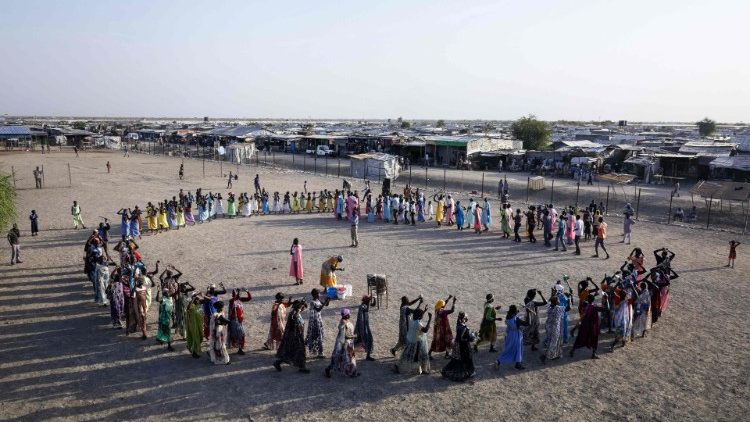 Internally displaced persons take part in a traditional ceremony at a protection of civilian site in Malakal. Around 30,000 displaced people inhabit the camp. 