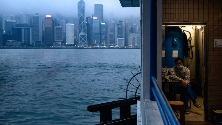 A worker in Hong Kong wears a face mask as a preventative measure against the COVID-19 cornavirus  