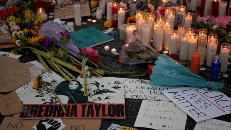 Candles and flowers at a makeshift memorial 
