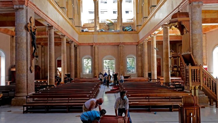 People clean up St George Maronite Church in Beirut center, 5 August