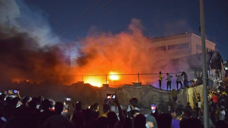 People take photos as flames engulf the coronavirus isolation ward of Al-Hussein hospital in Nasiriyah, Iraq