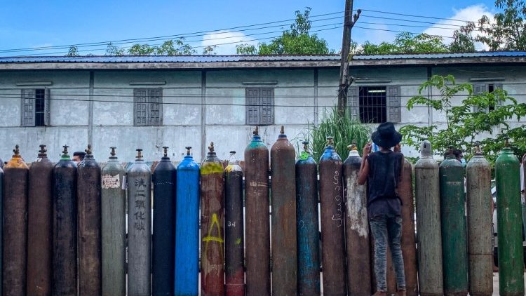  Empty oxygen cylinders await to be filled outside a factory in Yangon, amid a surge in coronavirus cases in Myanmar. 