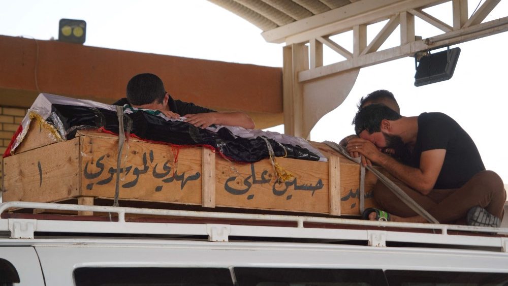 Enlutados assistem a um funeral em massa, para apoiadores do líder xiita Moqtada Sadr que foram mortos durante confrontos na Zona Verde de Bagdá, em um cemitério na cidade iraquiana central de Najaf em 30 de agosto de 2022. (Photo by Qassem al-KAABI / AFP)