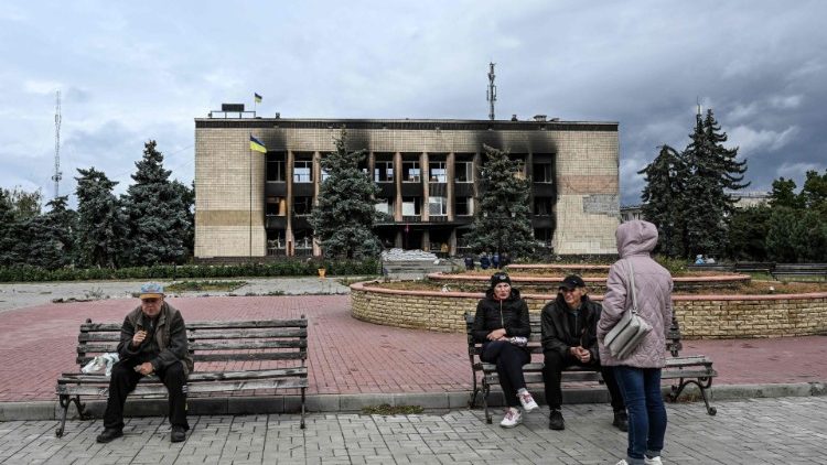 Moradores locais se reúnem em uma praça em Izyum, leste da Ucrânia, em 14 de setembro de 2022. (Foto de Juan BARRETO/AFP)