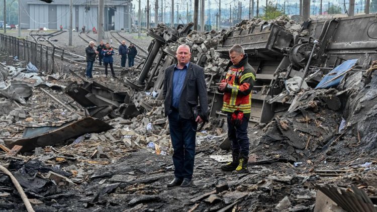 Trabalhadores inspecionam os danos perto de um pátio ferroviário da estação ferroviária de carga em Kharkiv, que foi parcialmente destruída por um ataque de mísseis, em meio à invasão russa da Ucrânia em 28 de setembro de 2022. - A Rússia disparou uma salva de mísseis em Kharkiv durante a noite, disseram autoridades em frente, atingindo um pátio ferroviário e cortando a energia para mais de 18.000 residências na segunda cidade da Ucrânia. (Foto de SERGEY BOBOK/AFP)
