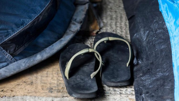 Flip flops sandals placed outside the tents at a makeshift refugee camp.