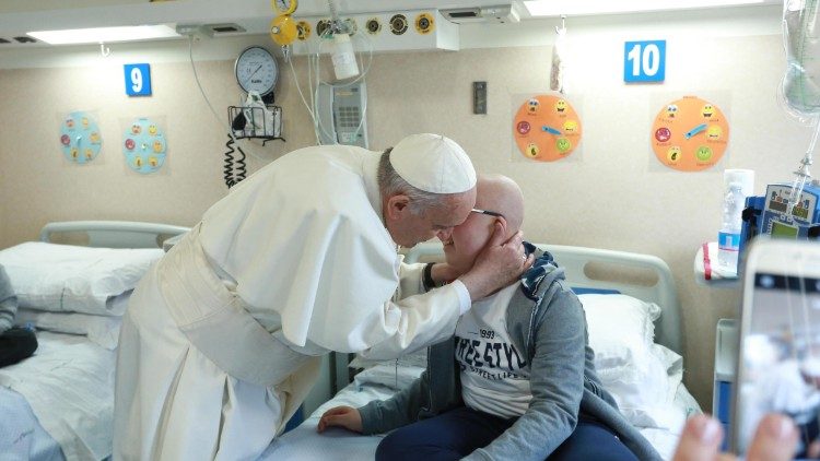 Pope Francis greeting patient at hospital founded by Padre Pio during his visit to San Giovanni Rotondo