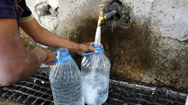 A bottle of drinking water filled up from a tap