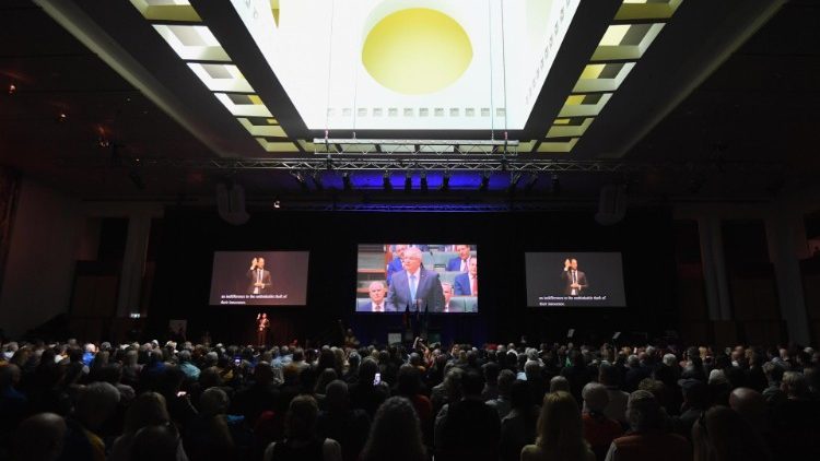 People watch Australian Prime Minister Scott Morrison deliver a national apology to victims of institutional sexual abuse