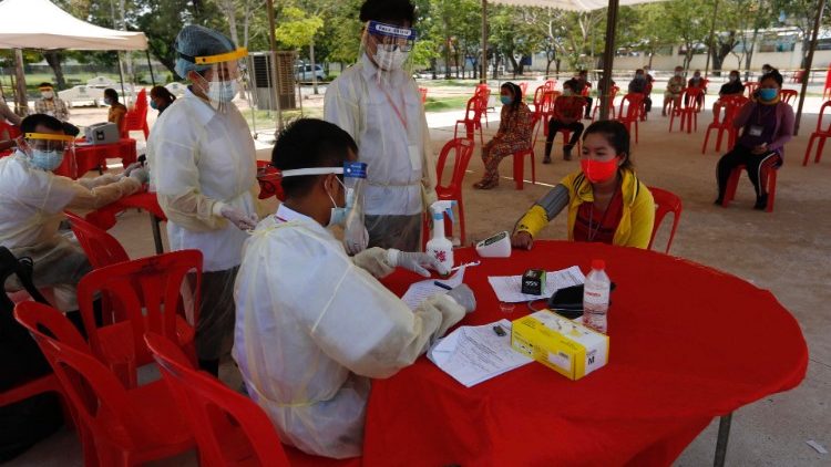 Workers in Phnom Penh, Cambodia, being screened for coronavirus infection.