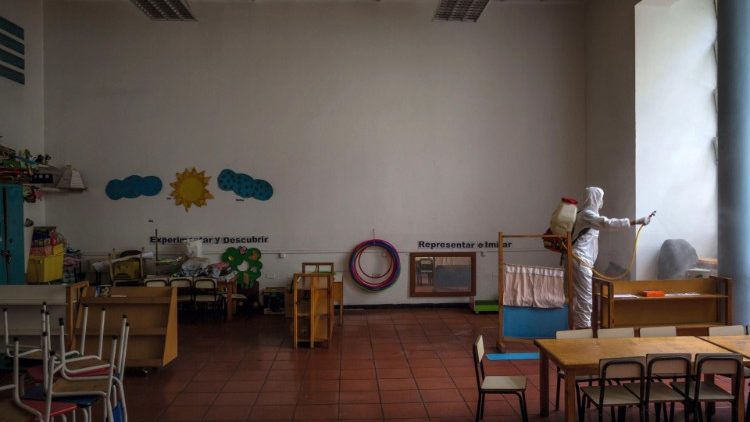 A health worker disinfecting a classroom as a preventive measure against Covid-19 in Venezuela