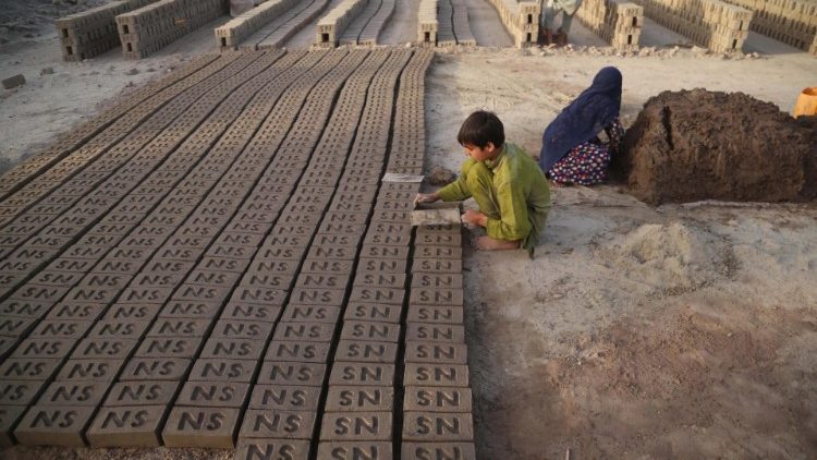 Afghan children engaged in a brick kiln. 