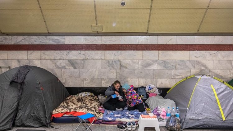 Ukrainian people stay at a subway station as Russia's attack on Ukraine continues
