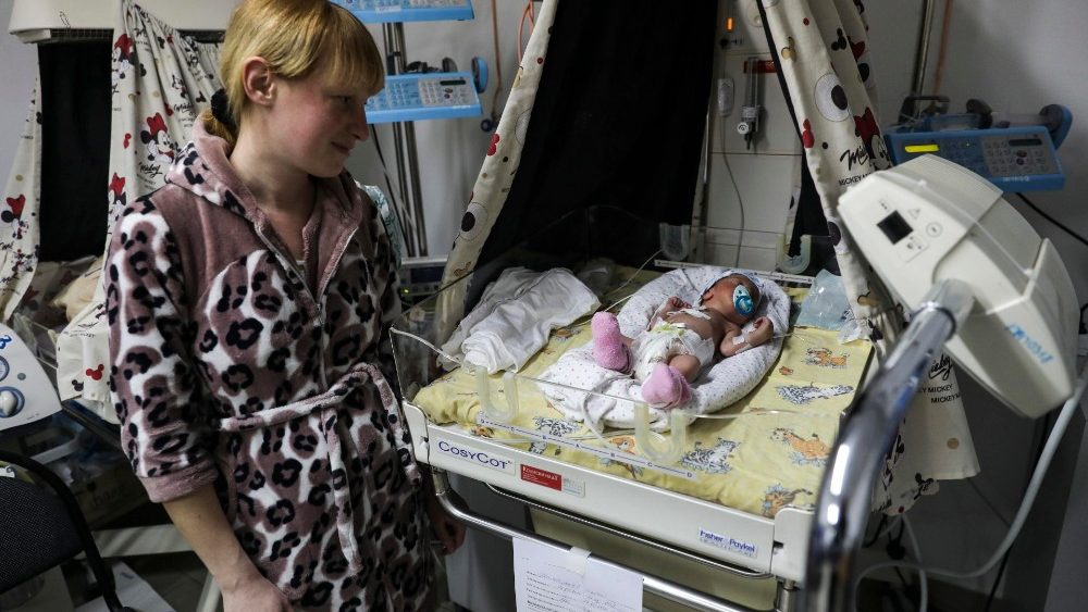Julia, olha para seu filho Maxime, nascido em 18 de março, no Centro Perinatal Regional de Zhytomyr em Zhytomyr, Kiev (Kiev) Ucrânia, 20 de março de 2022. Este Centro foi bombardeado no início da manhã de 20 de março. EPA/MIGUEL A. LOPES