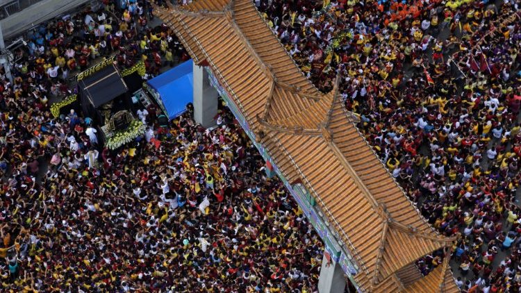 Catholic devotees surround the statue of the Black Nazarene on its feast day in Manila