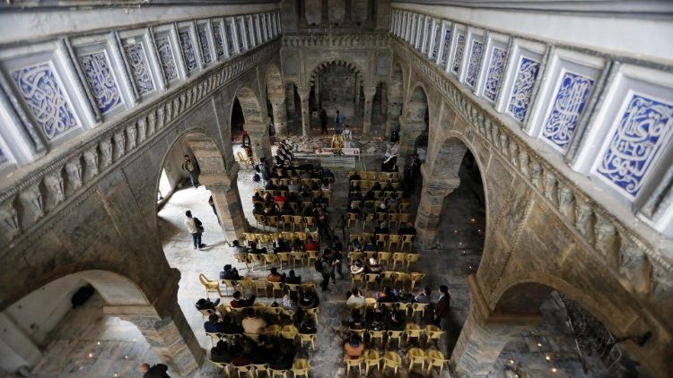 People at Mass at St. Thomas of Syriac, a Catholic church in the old city of Mosul, Iraq