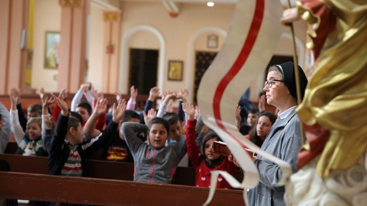 Nun leads a practice for some of the children who will receive first communion before Pope Francis's  in Rakovski, Bulgaria