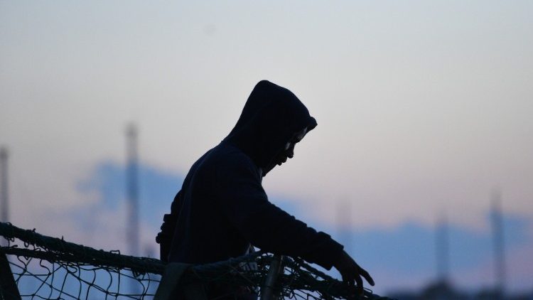 A migrant waits to disembark from a rescue ship in Lampedusa 