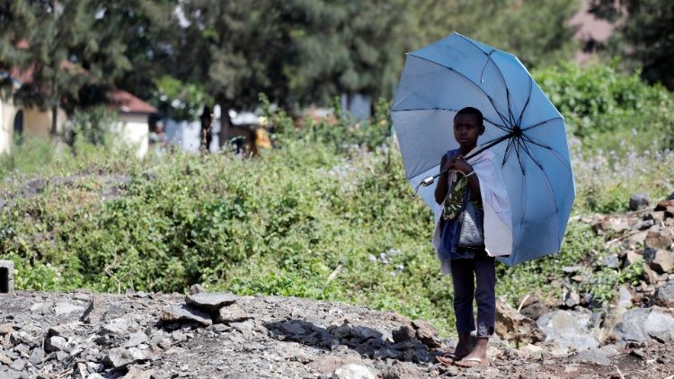 A girl stands alone near an Ebola treatment clinic in Goma, DRC