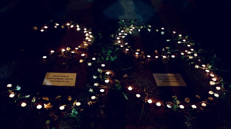 Candles are lit during a prayer for 39 people found dead in the back of a truck near London, in front of Hanoi Cathedral in Hanoi