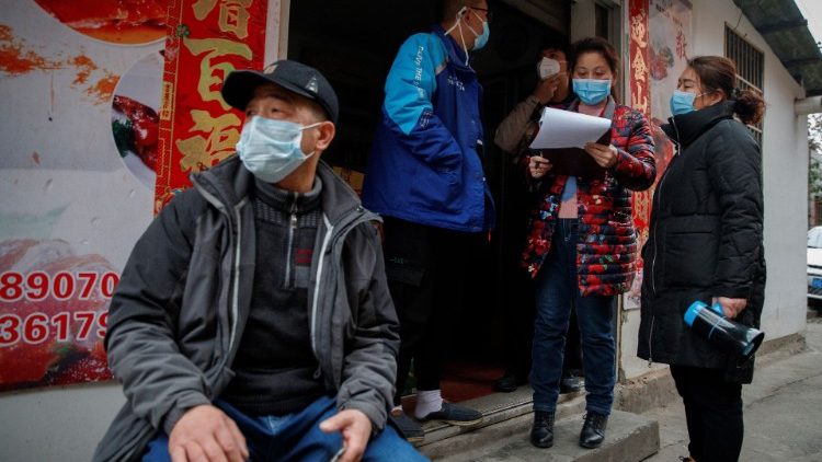 Members of a neighbourhood committee register a local and ask about his travel history in Jiujiang
