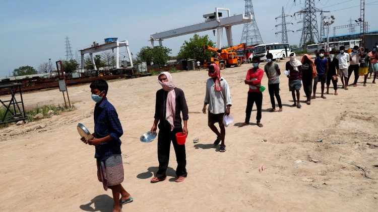 Labourers queuing for free food at a construction site during a nationwide lockdown in India