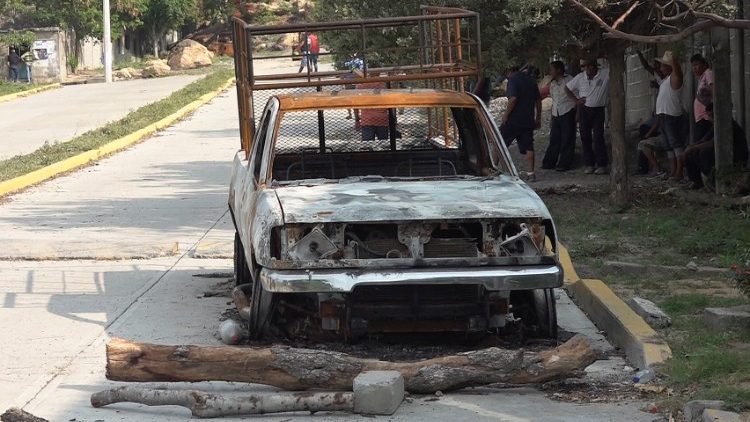The burnt wreckage of a truck lies on a street after assailants killed 15 inhabitants of an indigenous village, that has been plagued by local disputes, in San Mateo del Mar