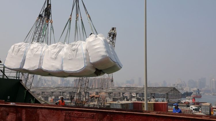 Humanitarian aid donated by World Food Program (WFP), are unloaded at Beirut's port
