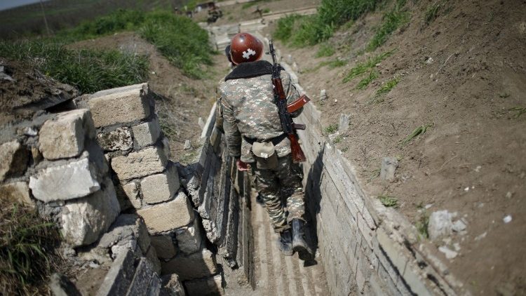 FILE PHOTO: Ethnic Armenian soldiers walk in a trench at their position near Nagorno-Karabakh's boundary
