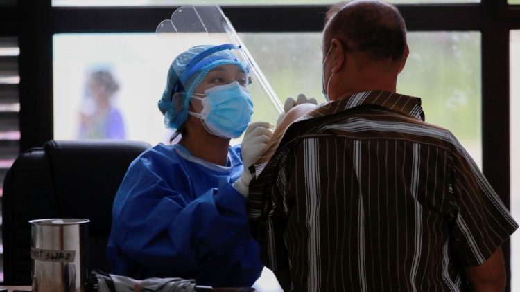 A health worker give a dose of the Covid-19 vaccine to a man in Kathmandu.  