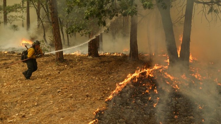 A firefighter fighting advancing fires in Indian Valley, California