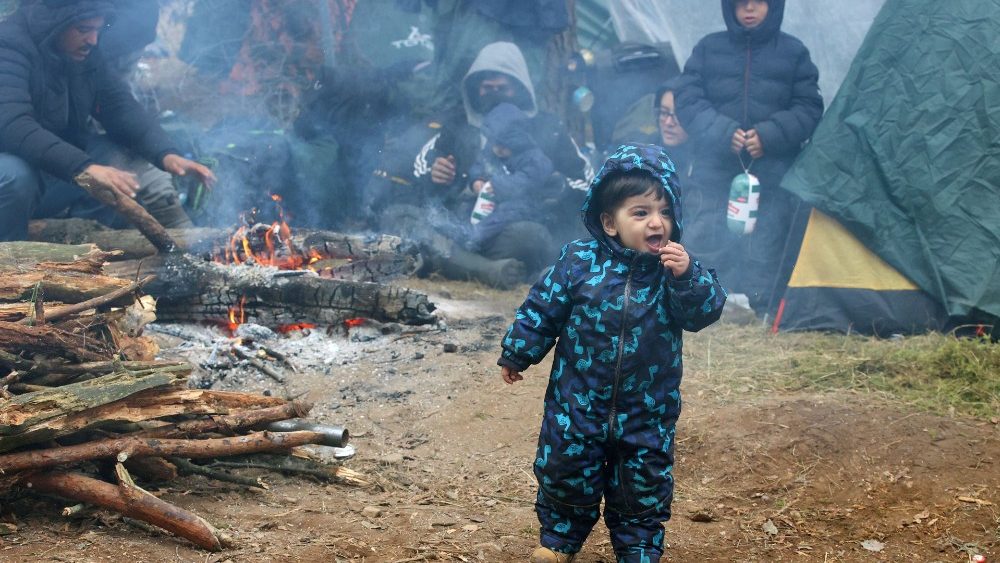 Migrants gather on the Belarusian-Polish border