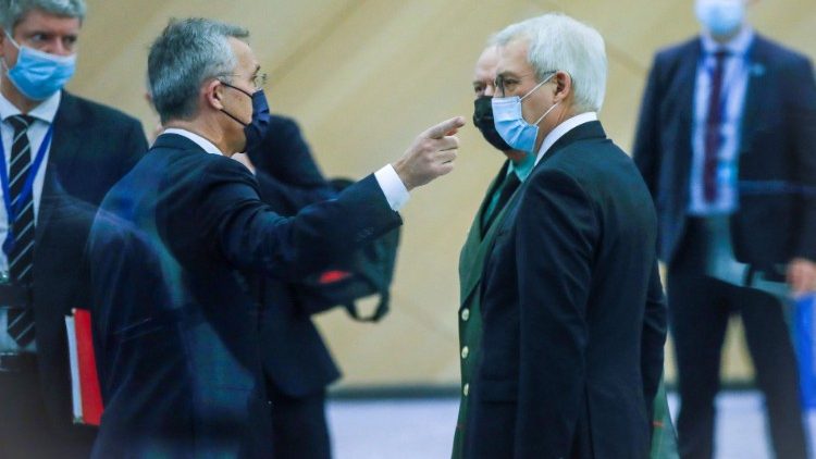 Il Segretario generale della Nato, Stoltenberg, dialoga con il viceministro degli Esteri russo, Grushko (Olivier Hoslet/Reuters)