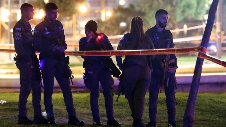 Israeli officials work at the scene of an attack in Tel Aviv