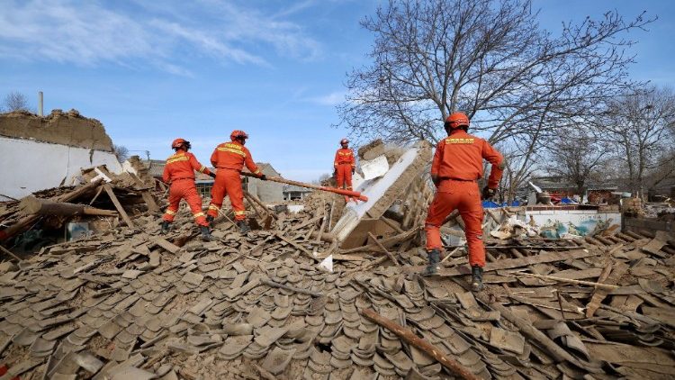Rescuers work amid the rubble at Shiyuan village following the quake