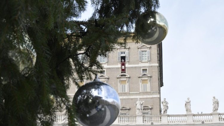 Pope Francis at the Angelus, seen through the branches of the Christmas tree in St Peter's Square