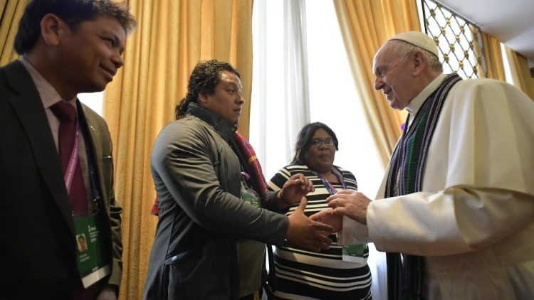 Pope Francis greeting indigenous peoples participating a forum in Rome