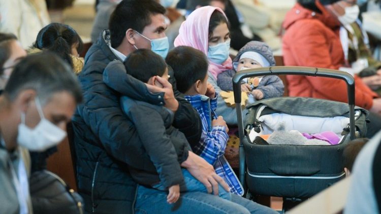 A family listens to the Pope