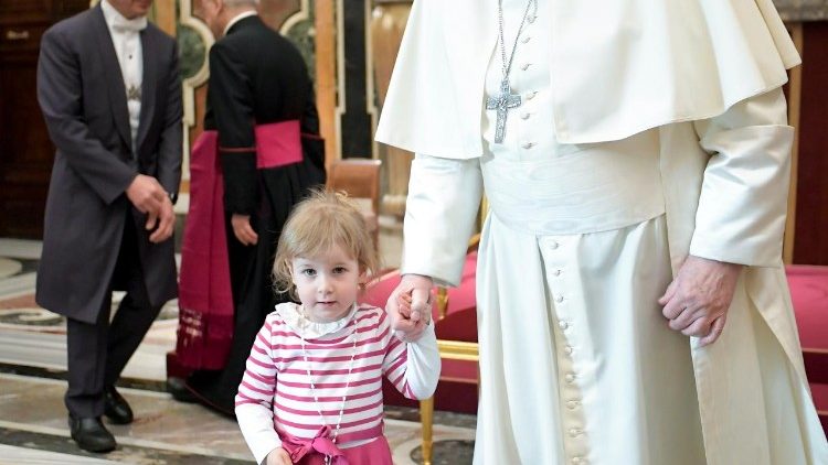 Pope Francis holds the hand of an offshoot of the leather industry