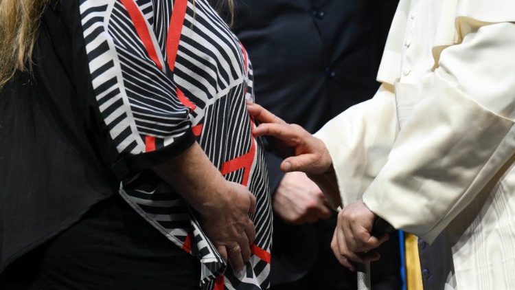 Pope Francis blesses a mother and her unborn child