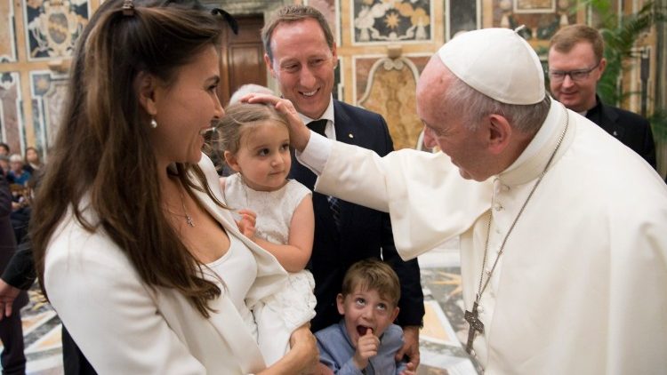 Pope Francis greeting mother and her little girl.