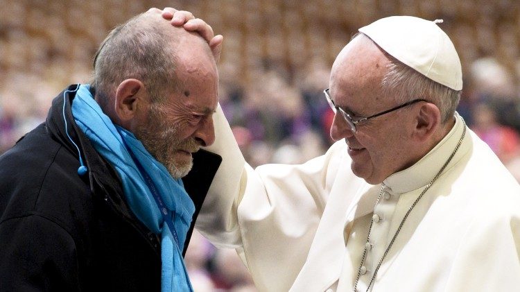 Pope Francis consoling a poor man.