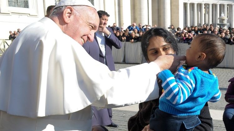 Pope Francis greeting a disabled child.