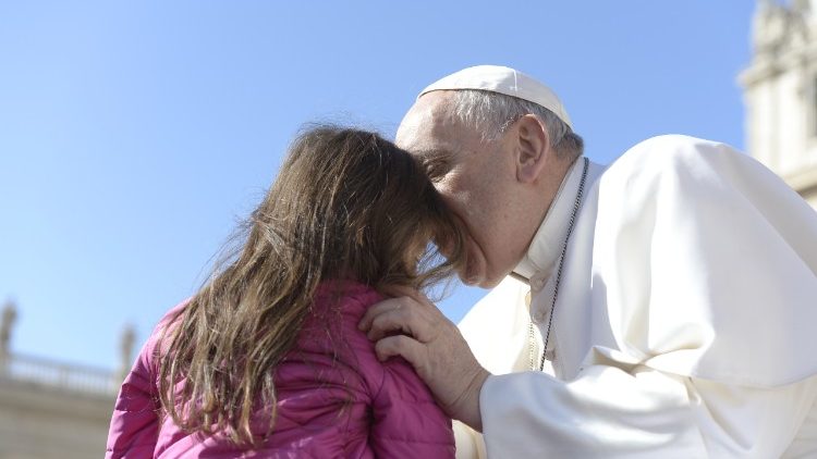 Pope Francis with young girl at his general audience.