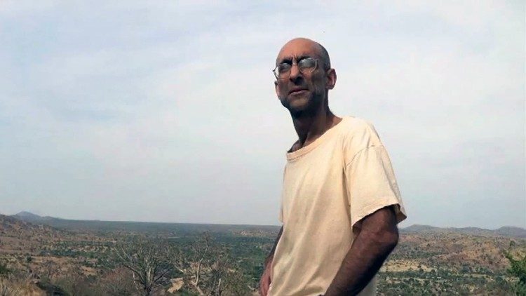 Tom Catena with Nuba Mountains in the background.  Photo credit: Sudan Relief Fund