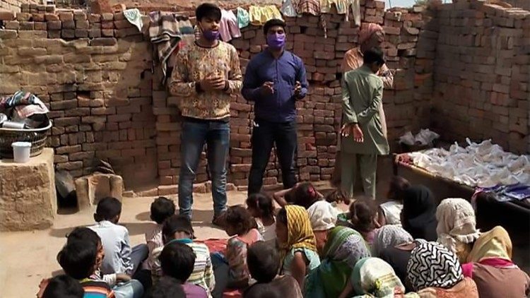 Vicky's brother praying before distributing food to poor children on Easter