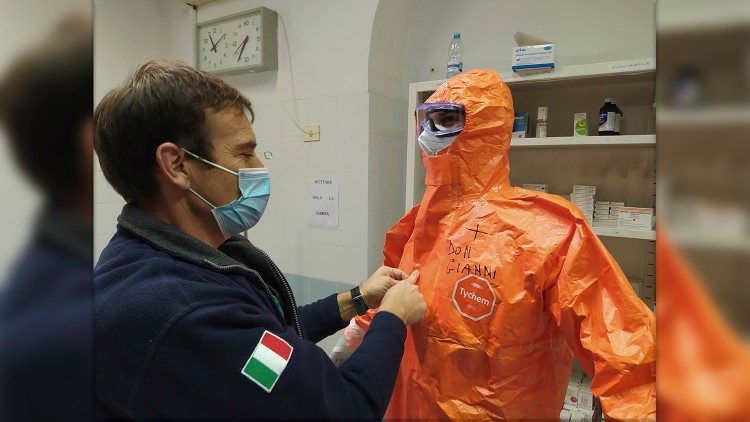 Don Mizzi alla vestizione prima di entrare nel reparto Covid del Celio