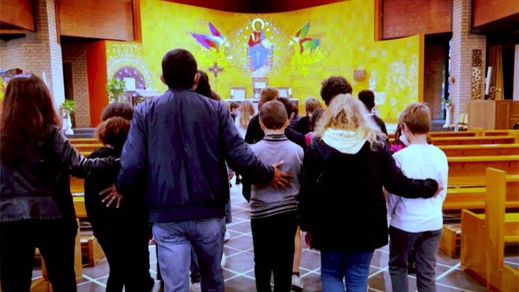 A catechist accompanying children in a church.